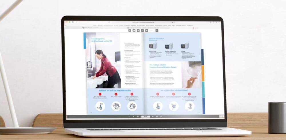 Laptop mit Schröter GmbH Unternehmensbroschüre, zeigt C-Artikel-Management und E-Procurement-Lösungen zur Prozessoptimierung.